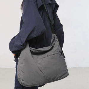 Minimalist large charcoal nylon crossbody bag with adjustable wide shoulder strap for women