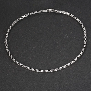 Polished silver titanium steel box chain necklace in a circular layout on black background