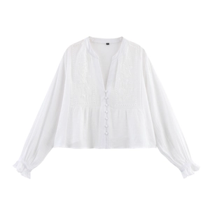 White long-sleeved deep V-neck shirt with embroidery and ruffled cuffs flat lay view