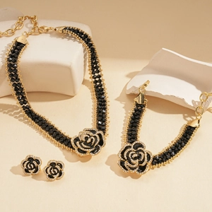 Dark rose floral jewelry set with black beaded necklace, bracelet, and stud earrings