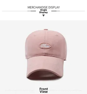 Detailed front view of a pink cotton baseball cap with embroidered logo and stitching