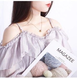 Close-up of rose gold interlocking triple ring pendant necklace on a female model