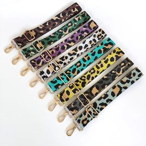 Detail view of 8 colorful leopard print nylon shoulder straps with gold metal swivel hooks