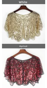Close-up of vintage sequined mesh shawls showing detailed geometric embroidery in white and apricot
