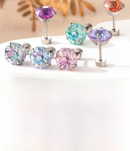Detail view of 6mm and 8mm firework cut gradient zircon stud earrings in titanium steel