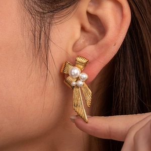 Vintage gold bow earrings with pearls and micro-pave crystals for a luxury look
