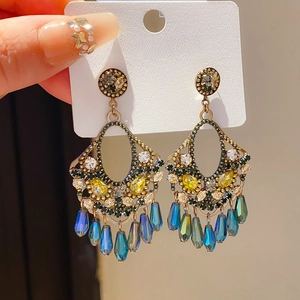 Close-up of vintage S925 silver earrings with yellow crystals and water-drop pendants