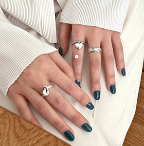 Close-up of minimalist 925 sterling silver knotted and textured ring set for women