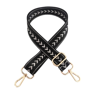Adjustable black nylon bag strap with white chevron pattern and gold metal buckles
