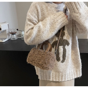 Close-up of brown faux fur box bag with a metal chain strap and top handle detail