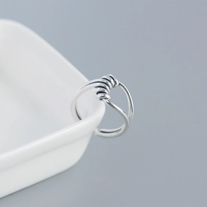 Macro detail of S925 sterling silver handmade knotted ring with wire wrap design