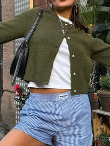Army green knit cardigan and blue striped shorts set for women in casual outdoor street style