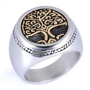 Macro view of two-tone stainless steel ring showing gold Tree of Life relief detail