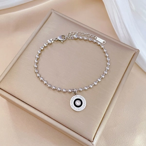 Macro view of stainless steel ball chain bracelet with sparkling pavé crystal pendant