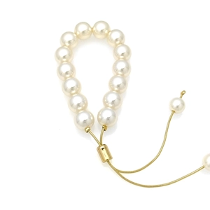 Close-up of adjustable 18k gold-plated slider clasp on a white pearl bead bracelet