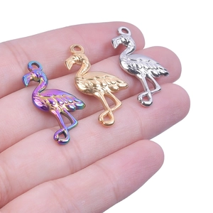 Macro shot of flamingo pendants in rainbow, gold, and silver finishes for DIY jewelry