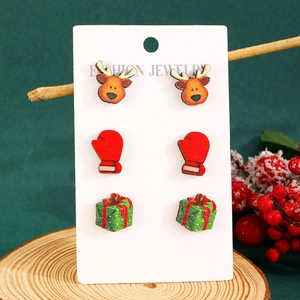 Detail of Christmas wooden earrings set featuring reindeer, gloves and gift box designs