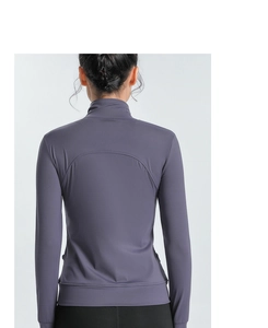 Close-up of slim-fit yoga jacket back showing curved seams and breathable purple fabric