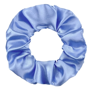 Detail of bright blue satin scrunchie showing the soft silk texture and elastic pleats