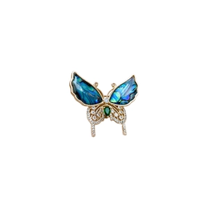 Broche papillon dorée avec ailes en nacre bleue et pierre précieuse vert émeraude