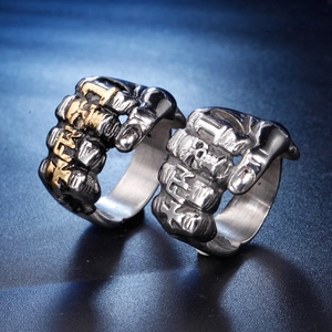 Macro detail of gothic skull fist rings in silver and black stainless steel finish