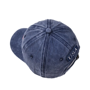 Close-up of vintage washed blue denim baseball cap featuring white USA letter embroidery