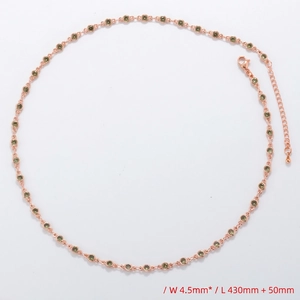 Detail showing rose gold necklace with 4.5mm green gemstones and lobster clasp extender