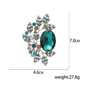 Detailed view of vintage crystal leaf brooch measuring 7.0cm in height and 4.6cm in width