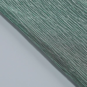 Gros plan sur le tissu en maille verte avec fils métalliques et texture ondulée