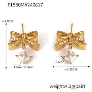 Detail of 18K gold-plated bow earrings with clear cubic zirconia and stainless steel studs