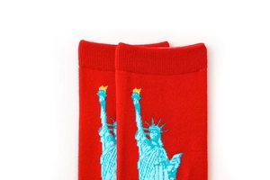 Detail of red crew socks with blue Statue of Liberty embroidery and ribbed cuff detail