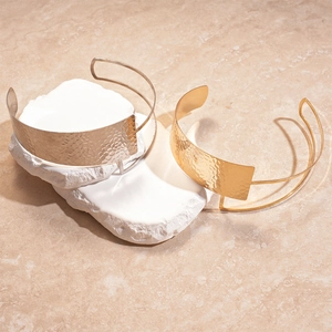 Detailed view of hammered texture on double-layer gold and silver metal chokers