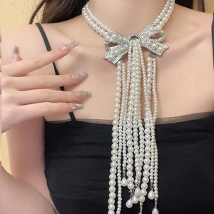 Elegant multi-layer pearl bridal necklace with rhinestone bow and long tassel accents