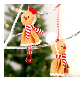 Charming gingerbread man plush ornaments with red scarves hanging on snowy branches