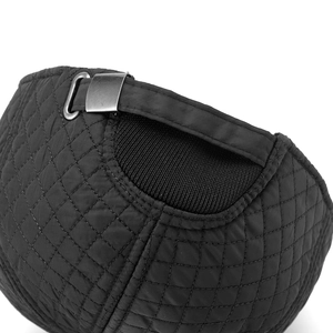 Detail of adjustable metal buckle and quilted diamond pattern on winter baseball cap