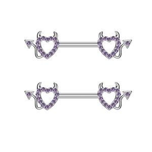 Macro shot of purple rhinestone devil heart nipple rings made of stainless steel