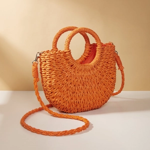 Bright orange crescent straw handbag with woven top handles and matching shoulder strap