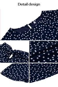 Détail du col rond et du nœud papillon au dos du chemisier bleu marine à pois blancs