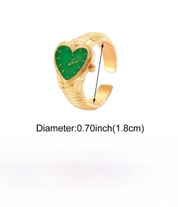 Close-up of vintage heart-shaped gold ring with green dial detail and alloy texture