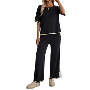 Women's black short sleeve knit set with contrasting beige piping and wide leg pants