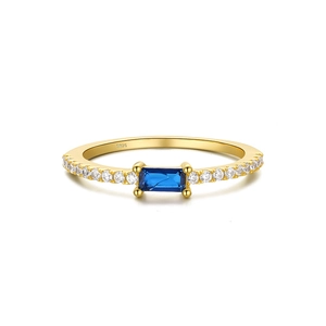 Macro shot of S925 sterling silver ring with blue gemstone and fine pave-set side stones