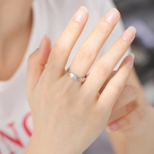 Minimalist stainless steel open ring with elephant pattern shown on a finger