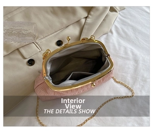 Detail view of pink pleated handbag interior with card slot and gold chain strap