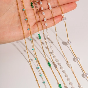 Detailed close-up of 18K gold plated stainless steel chains with multi-color pearls