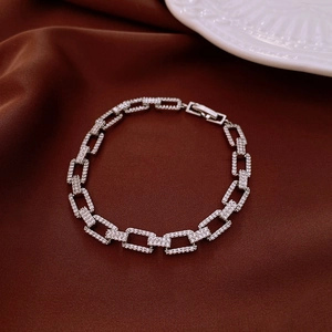 Macro detail of silver rectangular linked bracelet with embedded sparkling zircons