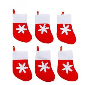 Set of 6 mini red Christmas stocking utensil holders with white snowflake appliqués