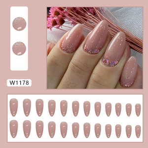 Almond-shaped nude pink press-on nails with purple glitter gradient for a sweet chic look