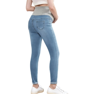 Detail of high waist maternity jeans with elastic belly support and slim fit design