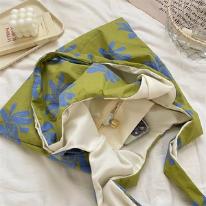 Detailed interior of blue floral canvas tote showing zipper pocket and spacious lining