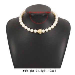 Detail of vintage pearl necklace with gold heart pendant and length measurements